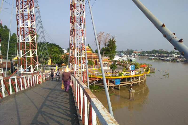 Life in Chau Doc is organised around the river: locals struggle to negotiate a steep arch bridge