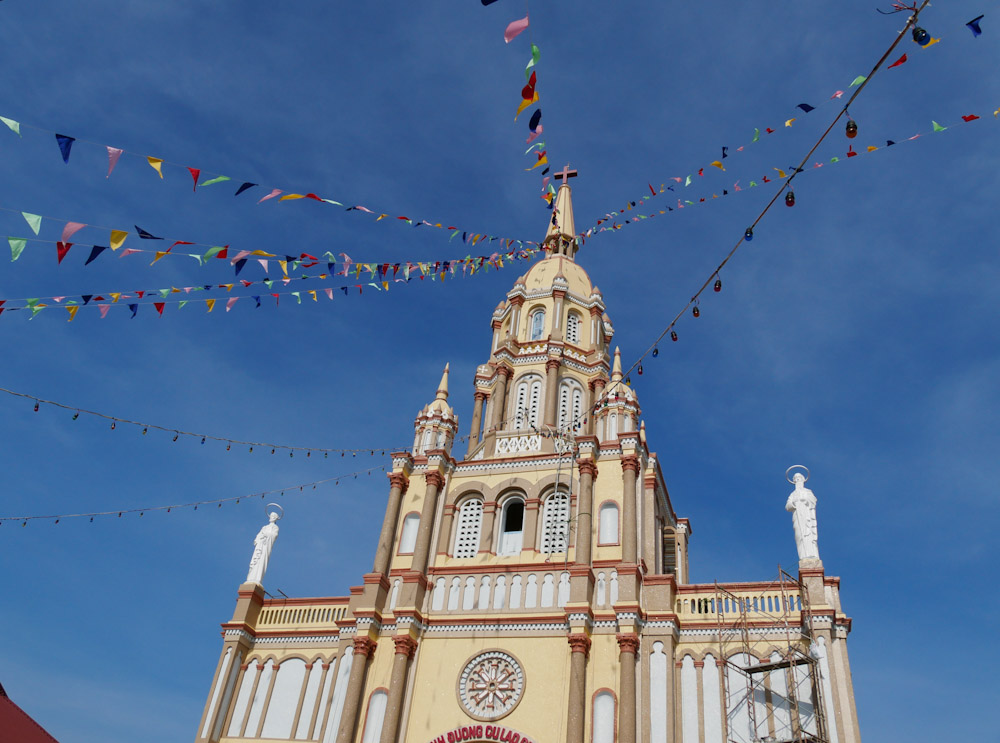 Flags and bunting fly from the top of  Cu Lao Gieng Cathedral in the Mekong Delta.