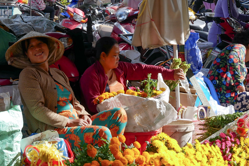 Cheerful lower sellers at Sa Dec's main market wear colourful clothes. 