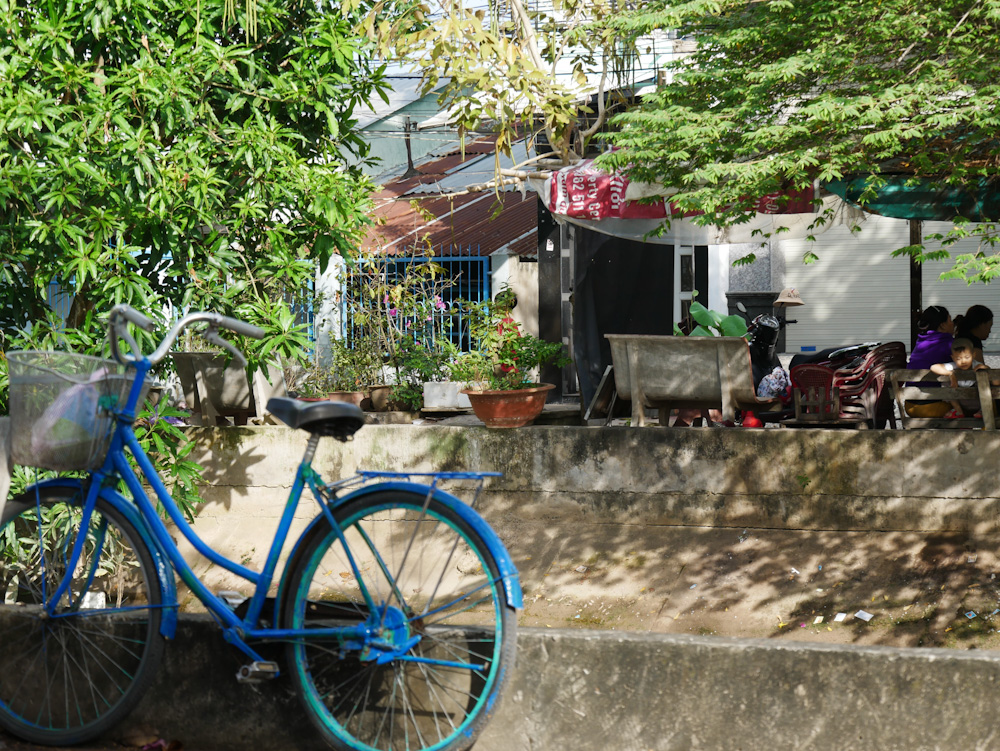 A blue bicycle next to the canal in Sa Dec, Vietnam. 