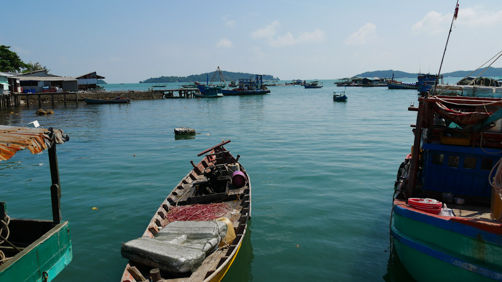 Fishing boats moored in turquoise waters at Hai Tac's main vilage