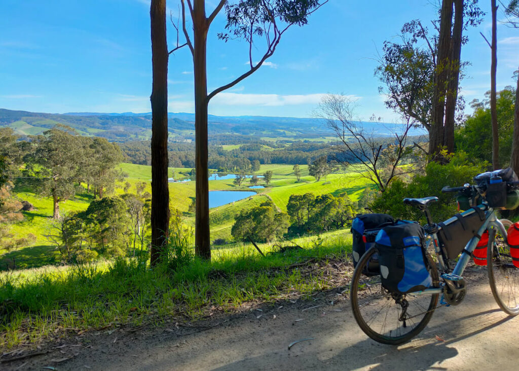 Bicycle in front of a view of hills and paddocks on the Hedley Range Road